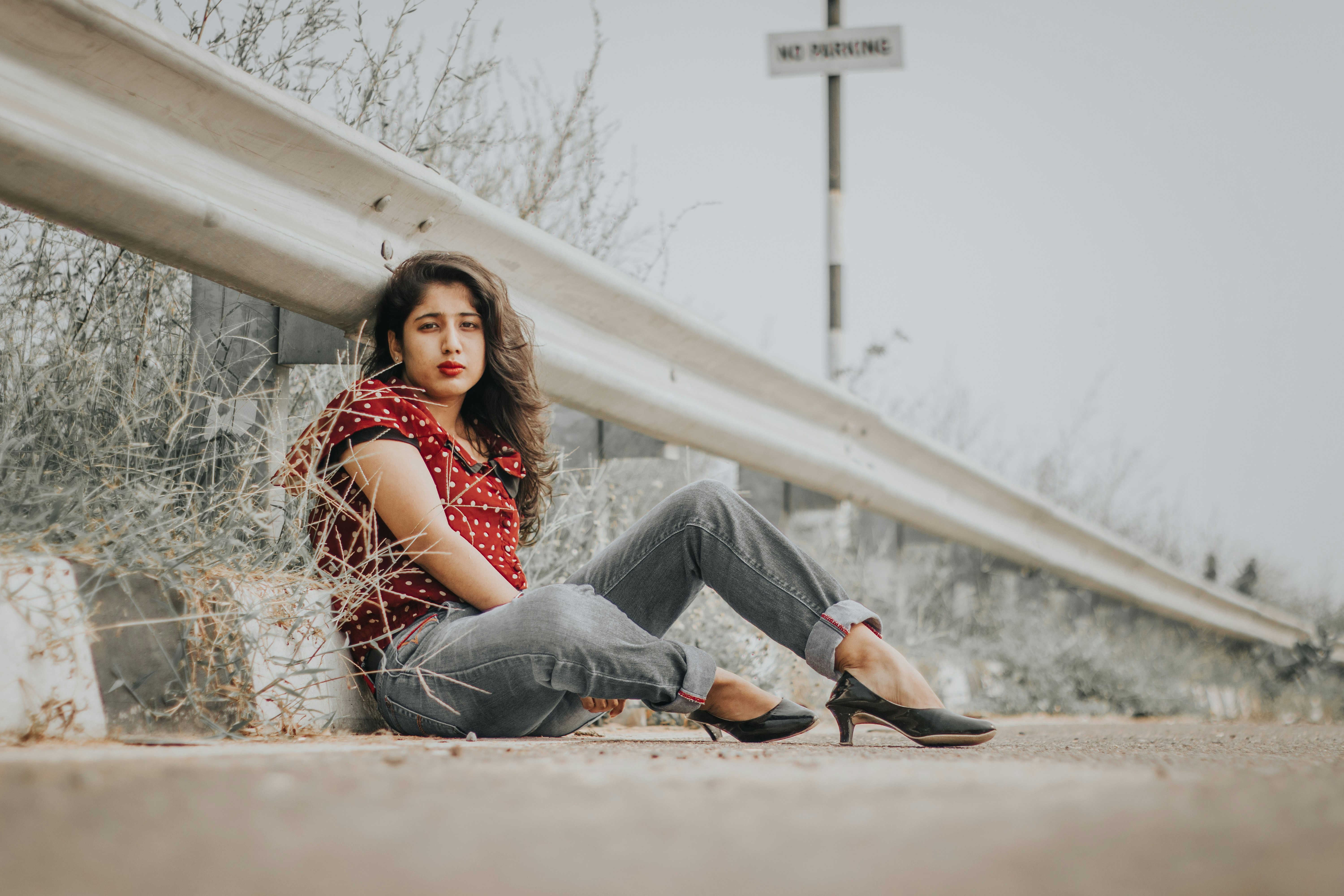 woman wearing grey denim jeans and red shirt